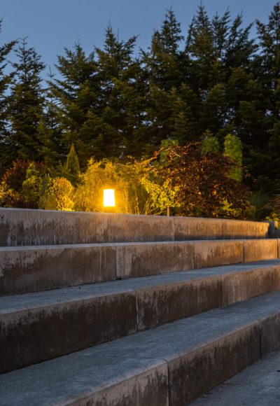 Large Garden Concrete Stairs and Illuminated Rockery Garden. Residential Architecture.